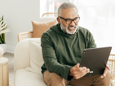 A man taking a health assessment on his laptop