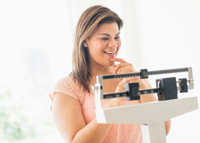 A woman standing on a scale