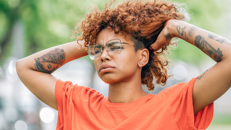 Woman holding up her hair to cool off.