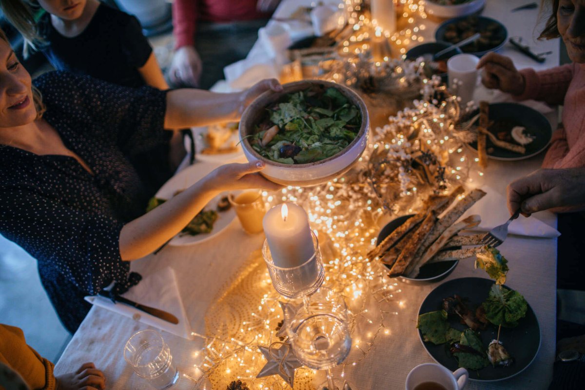 Passing around a healthy side dish at a holiday table.