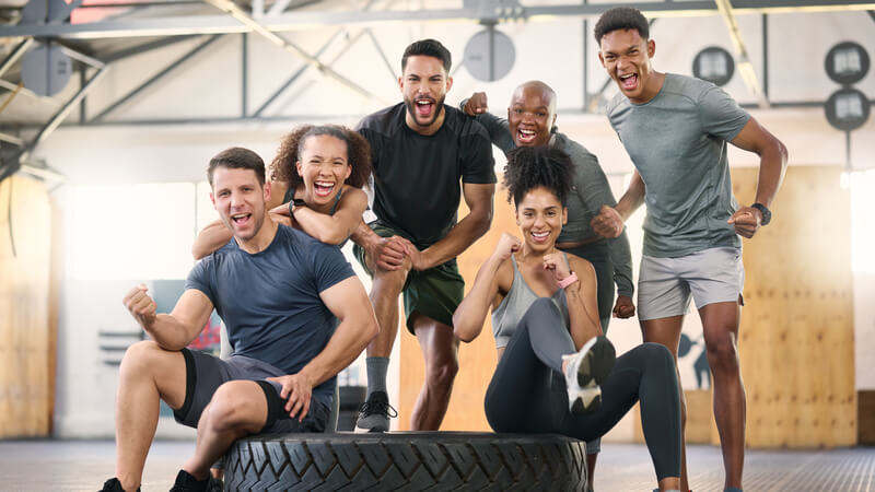 A group of athletic people in a gym setting.