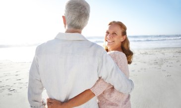 A man and woman standing on the beach