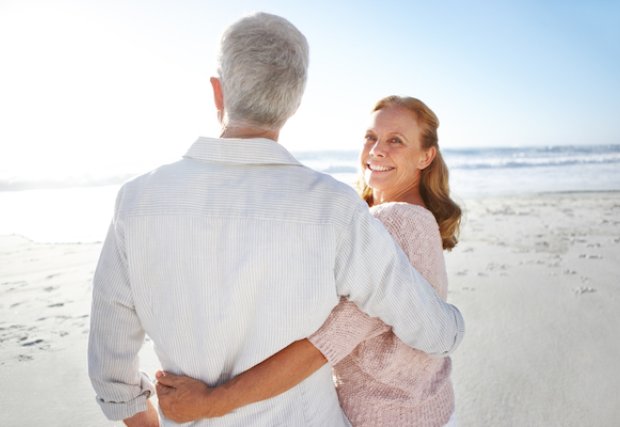 A man and woman standing on the beach