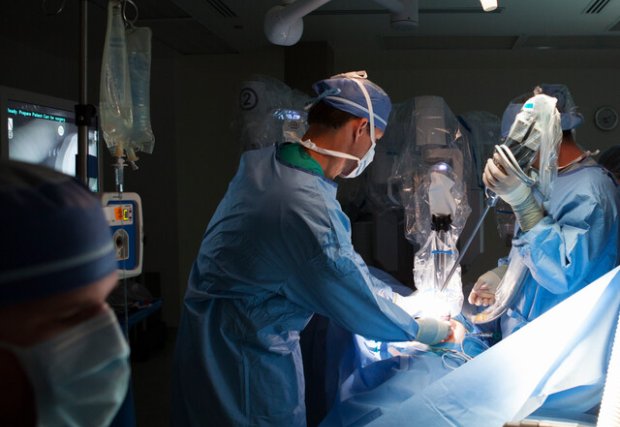 A medical team performing a robotic surgery