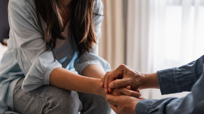 Person comforting a young person.